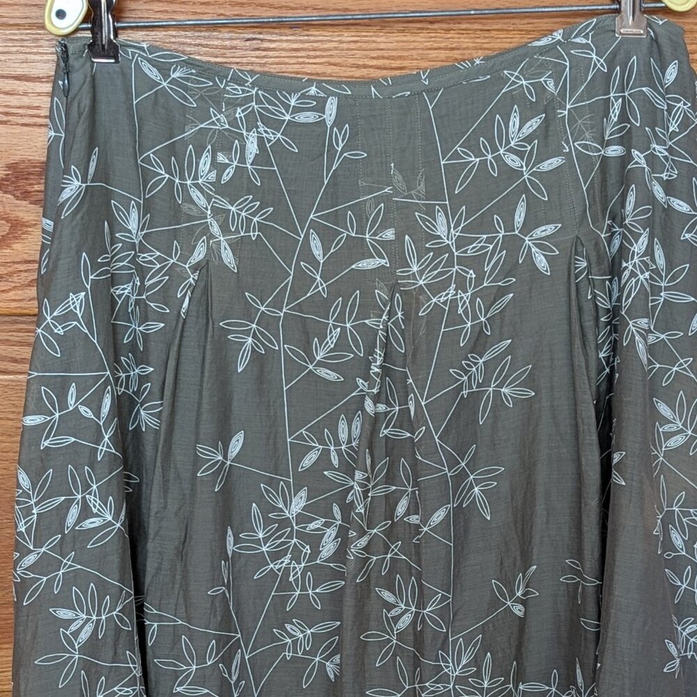 Calvin Klein lined silk skirt size12 with white design on sage green ground.